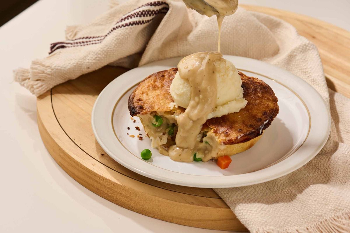 Chicken pot pie topped with mashed potatoes and gravy